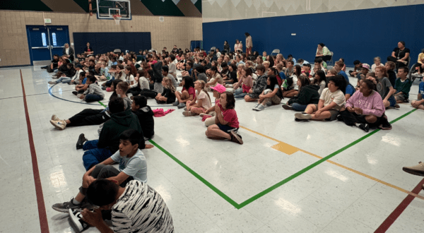 Students sitting during an assembly listening to author Johan Twiss